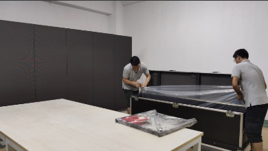 Two men unpacking furniture in room