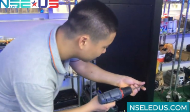 Man using a drill on equipment